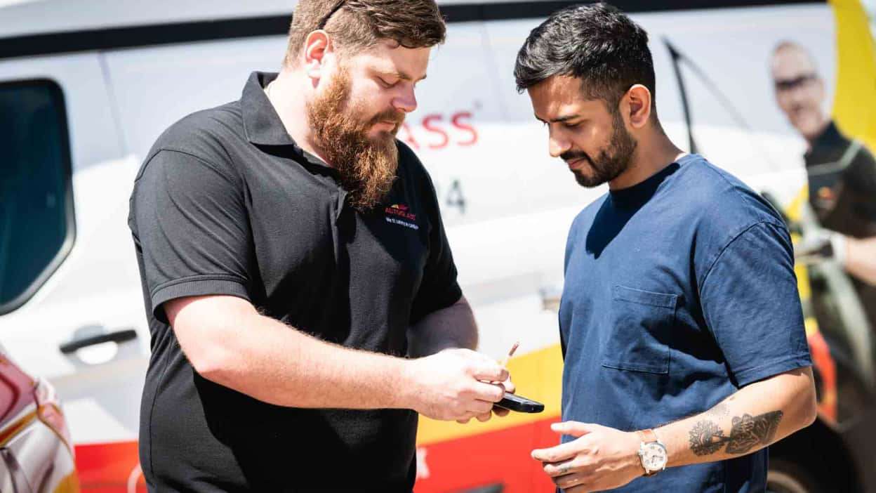 Technician from Autoglass with customer