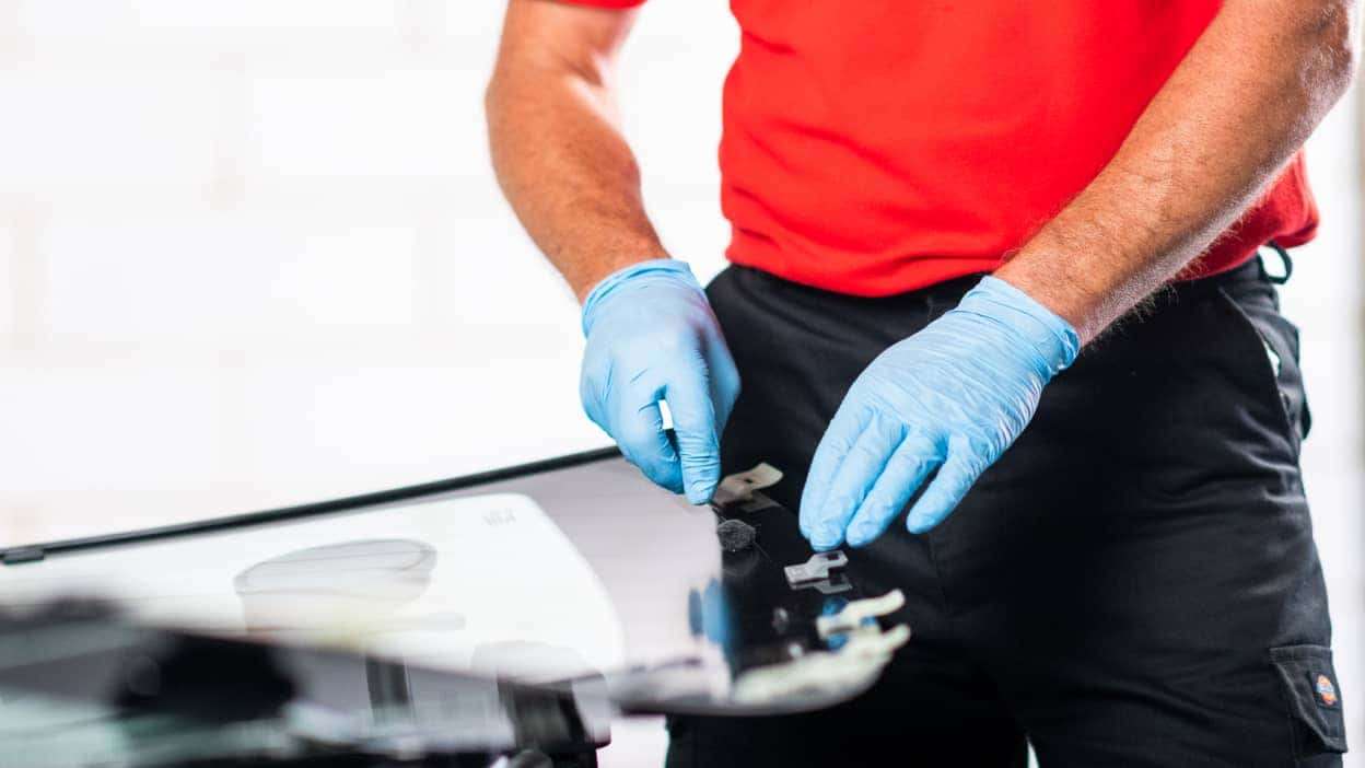 A technician at Autoglass® carrying out a rear window replacement