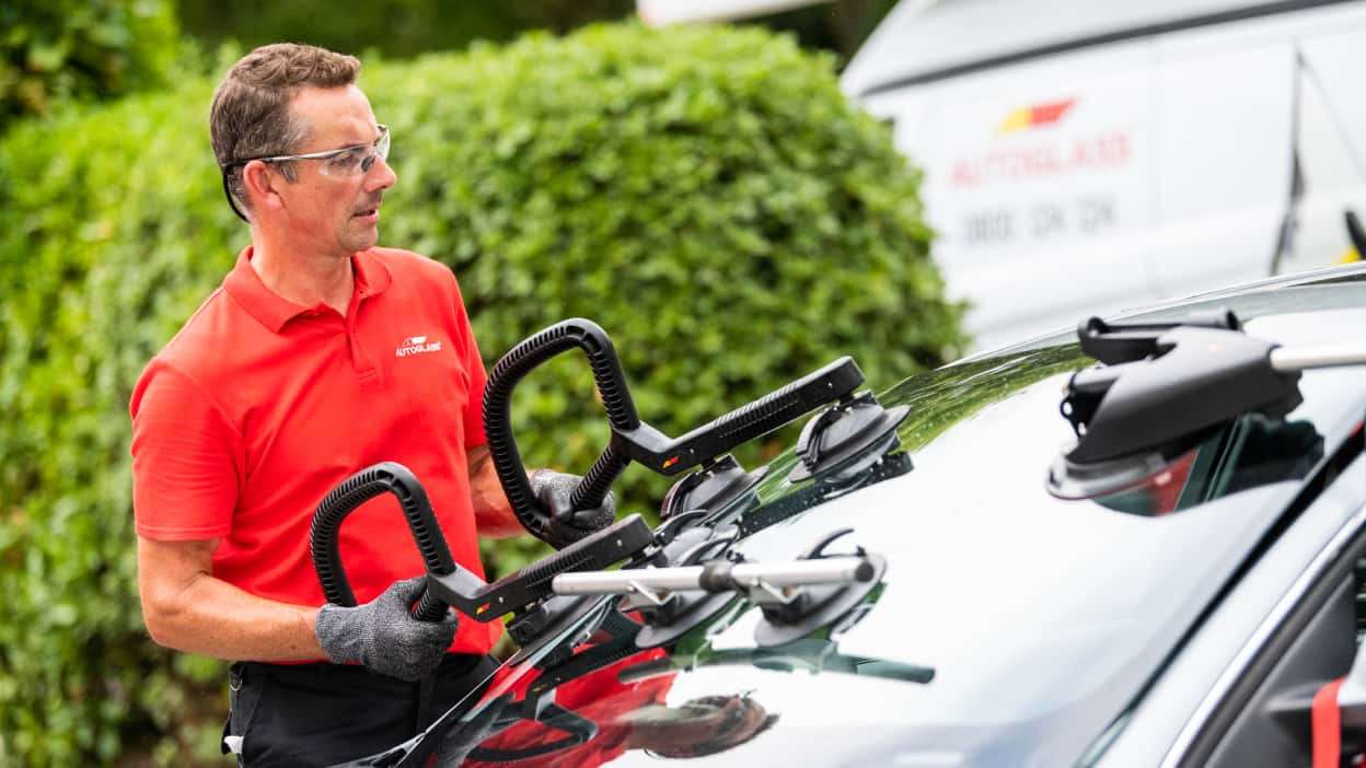 Technician replacing windscreen