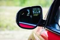 A car's wing mirror showing blind spot awareness